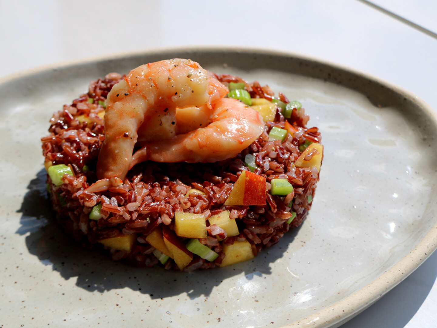 Red rice with prawns, celery and peaches