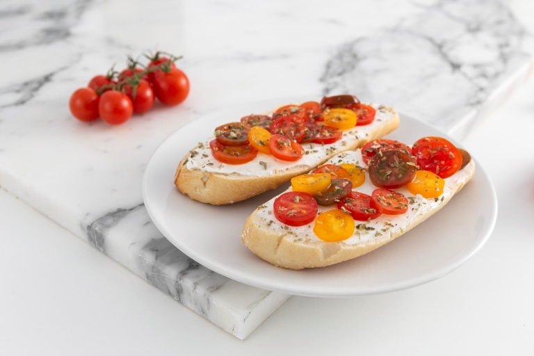 Bruschette with ricotta cheese cream with two tomatoes